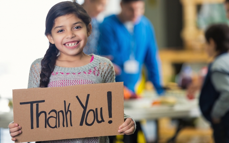 Girl holding Thank You sign